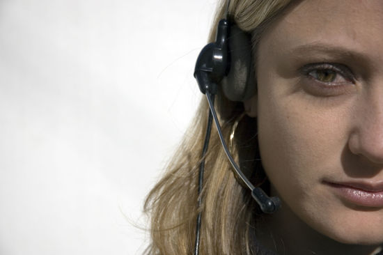partial face of a woman on headset
