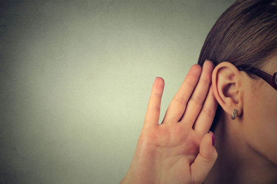 woman cupping her ear