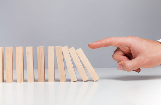 row of wooden block being triggered to fall